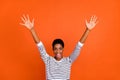 Photo of cute impressed butch lady dressed sweater rising arms smiling isolated orange color background