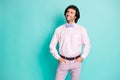 Photo of cute interested wavy hair gentleman dressed pink looking empty space hands arms pockets isolated turquoise