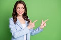 Photo of cute lady curly hairstyle indicate look fingers empty space wear blue blazer isolated green color background