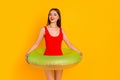Photo of cute shiny woman wear swimsuit empty space standing inside buoy isolated yellow color background Royalty Free Stock Photo
