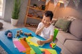 Photo of cute sweet boy sit desktop writing letters on art craft lesson in comfort cozy domestic playroom