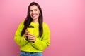 Photo of cute thoughtful girl dressed yellow sweater drinking tea looking empty space isolated pink color background Royalty Free Stock Photo