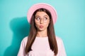 Photo of cute tricky girl lady dressed pink t-shirt hat pouted lips look empty space isolated teal color background