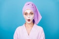 Photo of cute woman foam white mask open mouth wear purple towel turban bathrobe isolated blue color background