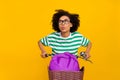 Photo of cute young lady drive bicycle look promo wear glasses green t-shirt bag isolated on yellow background Royalty Free Stock Photo