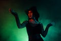 Photo of dangerous lady magician spell necromancy powerful diabolic creature from green mist background hell Royalty Free Stock Photo