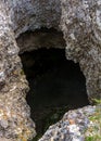 Photo of dark cave hole in the rock