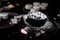 The photo in the dark gray scheme.Grey cake macaron. Macro. Blueberries, which rolled in powdered sugar. Royalty Free Stock Photo