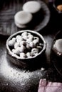 The photo in the dark gray scheme.Grey cake macaron. Macro. Blueberries, which rolled in powdered sugar. Royalty Free Stock Photo