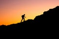 Photo in a dark key of a man climbing a mountain