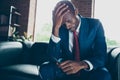 Photo of dark skin guy sitting office sofa hold head on hand feel dizzy wear elegant costume