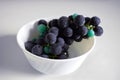 Photo of dark violet grapes in a cup