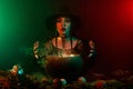 Photo of dark witch lady using cauldron doing magic fortune future telling on halloween night Royalty Free Stock Photo