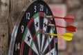 Dart board with darts arrows