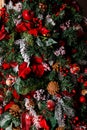 Photo of decorated Christmas tree with cones, red berries, leaves Royalty Free Stock Photo