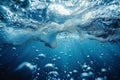 Photo of deep blue ocean water, light bubbles at the surface, underwater view, low angle shot, wideangle lens, hyperrealistic Royalty Free Stock Photo
