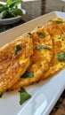 Photo of a delectable Thai omelette with crispy edges and fluffy texture served on a white platter Royalty Free Stock Photo