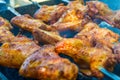 Photo of delicious chicken wings barbecue fried on charcoal in the park