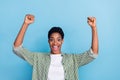 Photo of delighted astonished person raise fists celebrate triumph isolated on blue color background Royalty Free Stock Photo