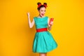 Photo of delighted girl blogging use cellphone raise fists scream win wear skirt isolated shine color background