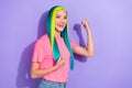 Photo of delighted lady yellow turquoise haired raise fist achieve victory isolated over purple color background