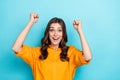 Photo of delighted overjoyed lady raise fists attainment luck scream yeah hooray isolated on blue color background