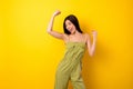 Photo of delighted overjoyed thai person raise fists triumph attainment isolated on yellow color background