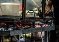 Photo depicting people making a grilled meat immersed in smoke. fire and coals.