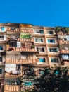 The photo depicts a high-rise apartment building with a modern design