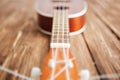 Photo depicts musical instrument ukulele guitar on a wooden Royalty Free Stock Photo