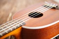 Photo depicts musical instrument ukulele guitar on a wooden Royalty Free Stock Photo