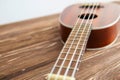 Photo depicts musical instrument ukulele guitar on a wooden Royalty Free Stock Photo