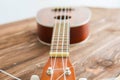 Photo depicts musical instrument ukulele guitar on a wooden table Royalty Free Stock Photo