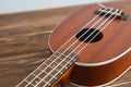 Photo depicts musical instrument ukulele guitar on a wooden table Royalty Free Stock Photo