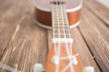 Photo depicts musical instrument ukulele guitar on wooden table Royalty Free Stock Photo