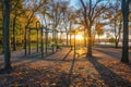 This photo depicts a park with a swing set surrounded by trees in a serene outdoor setting, A sunset view on a open-air gym at a Royalty Free Stock Photo