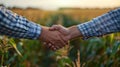 Harvesting Success: Two Farmers Shake Hands in Corn Field, Happy with Agreement Royalty Free Stock Photo