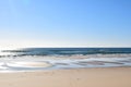 Deserted natural beach with calm blue sea and sun reflections, Manta Rota, Algarve, Portugal Royalty Free Stock Photo