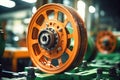 Photo of a detailed shot of a mechanical device with an orange wheel. Modern metal processing at an industrial enterprise.