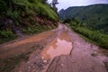 Dirt road in spring mountains with lots of muddy puddles after the rain - Sainj Valley, Kullu, Himachal, India