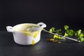 A photo of dirty empty ceramic bowl, spoon and some parsley. Messthetics aesthetic concept. Porridge, pumpkin cream soup leftovers Royalty Free Stock Photo