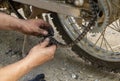 Photo of dirty mechanic`s hands holding a broken motorcycle chain for repairing Royalty Free Stock Photo