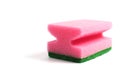 Photo of a dish sponge that consists of pink foam and green abrasive on a white background