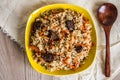 Photo of dish of uzbek pilaf made of rice and carrots, meat and onions