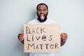 Photo of displeased crazy yell dark skin african protester hold placard against black citizens civil social lawlessness