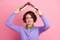 Photo of displeased lady hold open book above head crying happy end wear purple jumper isolated pink color background