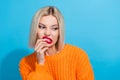 Photo of dissatisfied girl wear knit orange jumper disgusting look empty space finger touch lips isolated on blue color Royalty Free Stock Photo