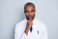 Photo of doctor handsome dark skin guy friendly smiling to patient virologist hold arm on chin experiment wear white lab Royalty Free Stock Photo