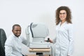 Photo of doctor treating patient in ophthalmological cabinet.