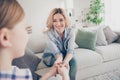 Photo of domestic charming blond lady mommy daughter relaxing comfy couch hold arms overjoyed stay home good mood